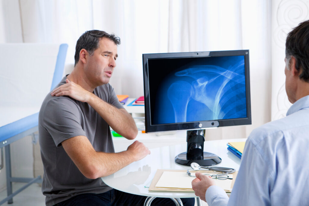 man telling his doctor about his shoulder pain